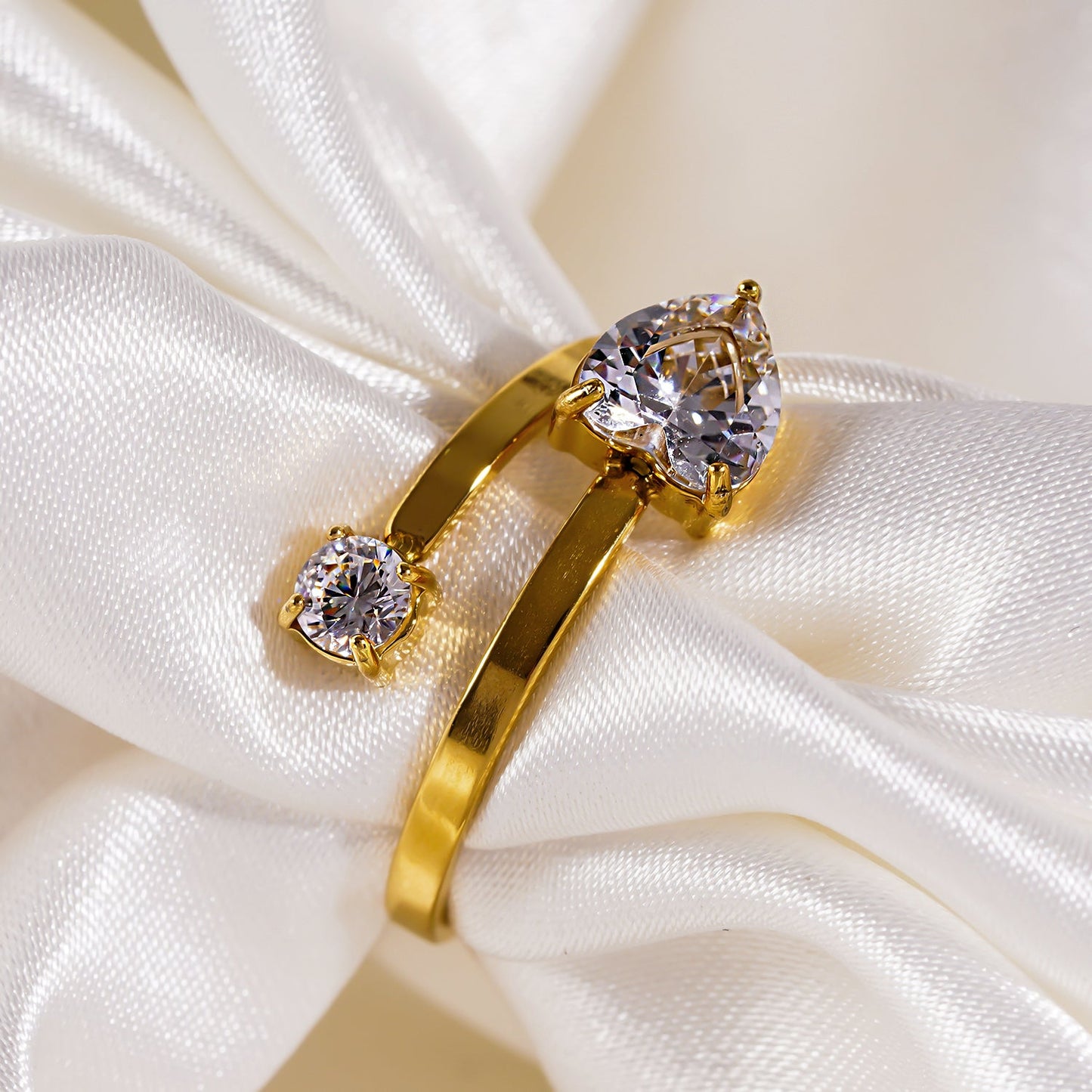 RIZALINA: Classic Band Ring Anchoring Heart Shaped & Rounded Zirconia Gemstones